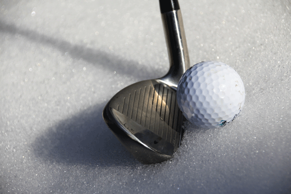 golf ball with a golf club on snow